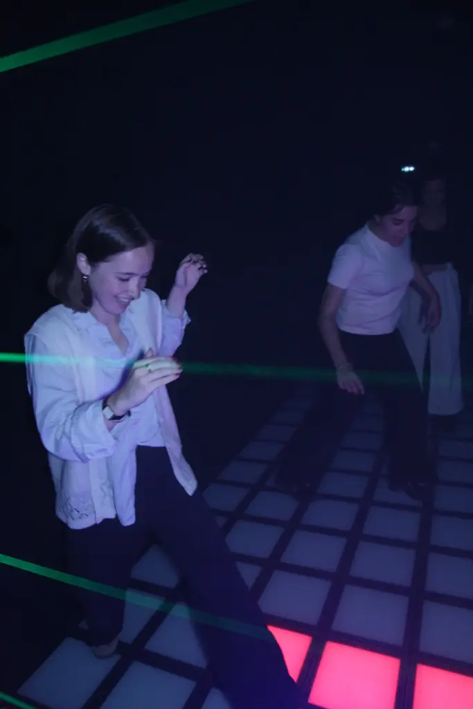 Personnes dansant sur une piste illuminée.